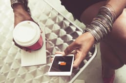 Un femme utilise l'application Orange Bank dans un caf