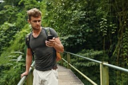 Homme utilisant son mobile lors d'une balade en fort