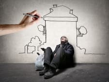 Une main dessine un logement au-dessus d'un sans-abri