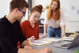 Des jeunes discutent autour d'un ordinateur.