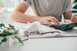 Un homme utilise une calculatrice.