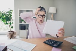 Une femme tonne devant un document.