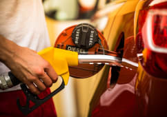 Main remplissant le r&eacute;servoir diesel d'une voiture avec pistolet.