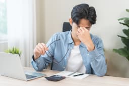 Concept de probl�me oculaire, jeune homme asiatique fatigu�, yeux fatigu�s chez l'homme, nez irrit� par le frottement, soulagement de la douleur oculaire apr�s le travail sur un ordinateur portable, fatigue oculaire, main tenant des lunettes, souffrant de migraine, mauvaise vision floue.