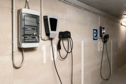 Station de recharge pour v&eacute;hicules &eacute;lectriques et compteur &eacute;lectrique pour la recharge de v&eacute;hicules personnels dans le parking souterrain urbain d'un immeuble d'appartements intelligent.