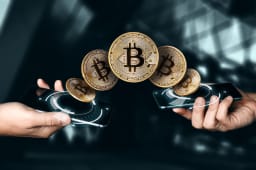 Deux mains &eacute;changent des bitcoins via smartphones num&eacute;riques.