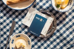 Carte bancaire et addition sur une table � carreaux bleus.