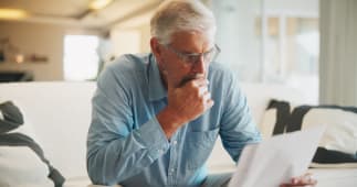Un homme regarde un document en s'interrogeant.