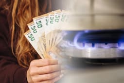 Une femme tenant des billets d'euro pr&egrave;s de la flamme d'une cuisini&egrave;re &agrave; gaz.