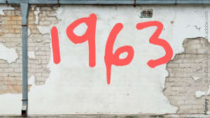 Mur avec le nombre 1963 peint en rouge.