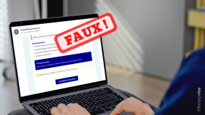 Personne consultant un email frauduleux sur un ordinateur portable. Faux chque energie