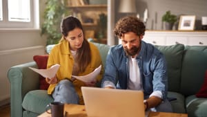 Un couple examine les documents d'assurance vie en ligne.