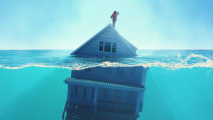 Une maison sous l'eau, avec quelqu'un sur son toit