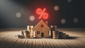 Maison, pièces de monnaie, symbole pourcentage, concept taux immobilier.