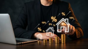 Homme en costume, pièces, maisons, pourcentages, investissement immobilier, ordinateur.