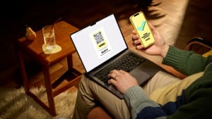 Homme payant en ligne avec ordinateur portable et smartphone.