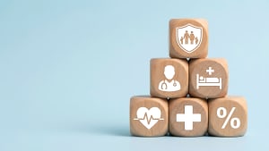 Pyramide de blocs en bois avec des symboles d'assurance santé.