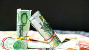 Close up of Euro money roll. Euro banknote set cash money - EU currency. Rolled with rubber euro notes. Banknotes stacked on each other in different positions