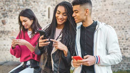 Jeunes utilisant leur smartphone en groupe