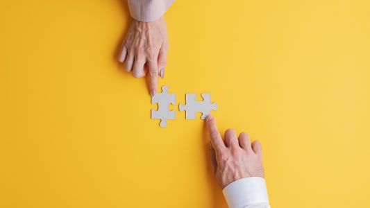 Deux personnes collaborent sur un puzzle