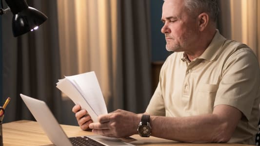 homme papier ordinateur