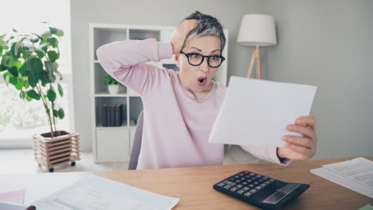 Une femme tonne devant un document.