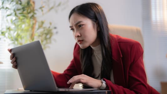 Une femme inquite devant son ordinateur