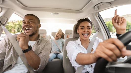 Un homme, une femme et un enfant dans une voiture.