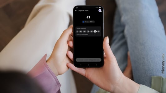 Personne tenant un smartphone montrant une application de finances, REVOLUT