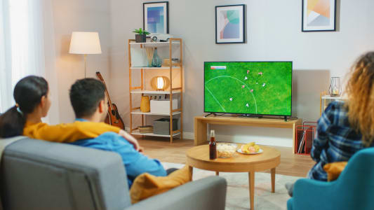 Un couple regarde du football  la tlvision