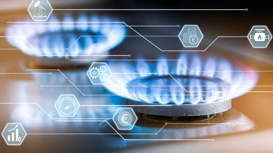 Une gazinire et des symboles autour du gaz et de son prix.